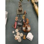 AN ASSORTMENT OF DECORATIVE MINIATURE VIOLINS, A HEAVY METAL STATUE OF A GIRL ON A PLINTH AND SOME