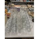 A LARGE COLLECTION OF GLASSWARE INCLUDING WINE GLASSES, TUMBLERS, CHAMPAGNE COUPLES ETC.