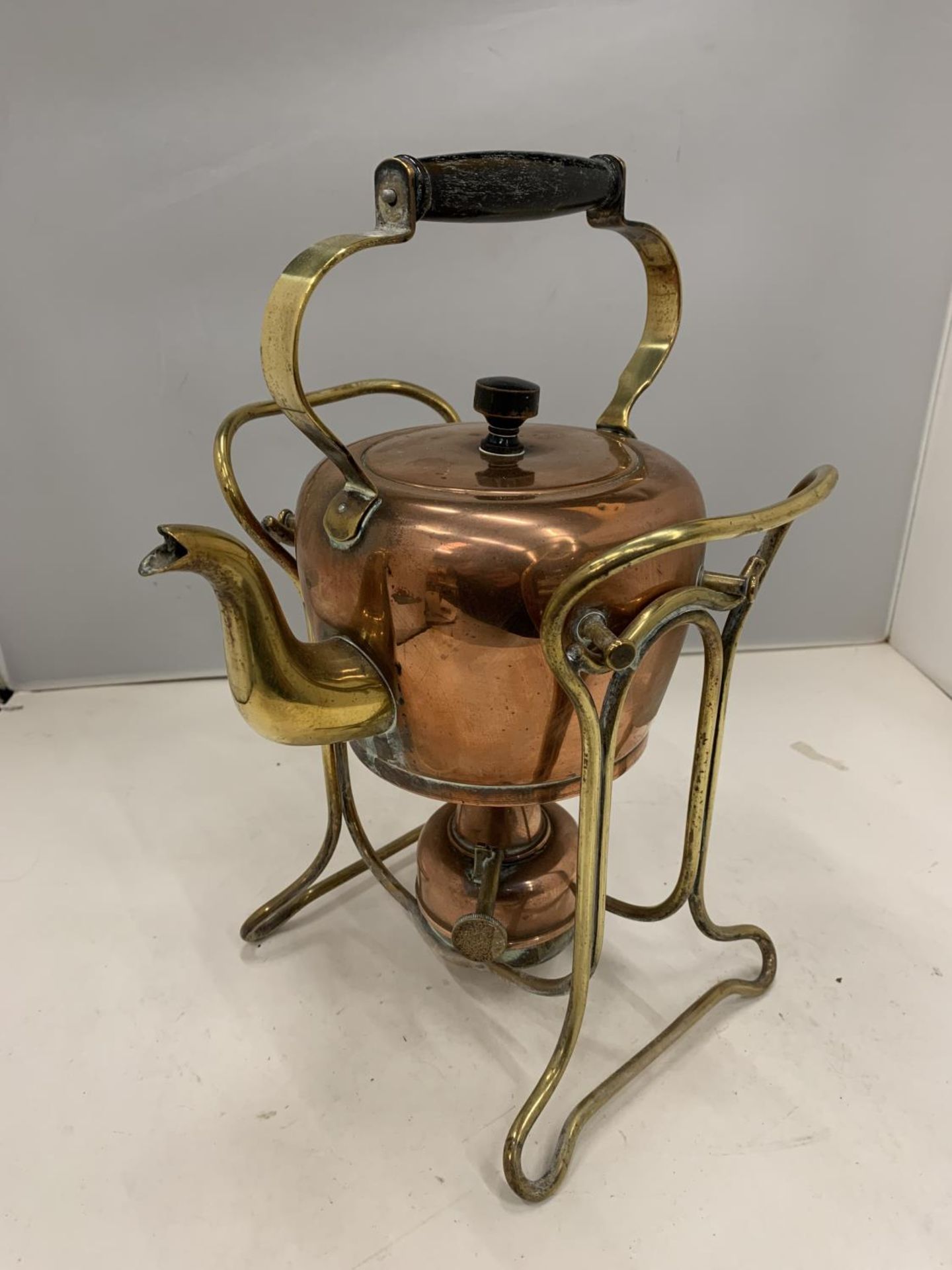 A BRASS AND COPPER SPIRIT KETTLE