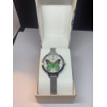 A LIMIT WRIST WATCH WITH A BUTTERFLY DESIGN IN A PRESENTATION BOX SEEN WORKING BUT NO WARRANTY