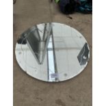 A CIRCULAR ART DECO UNFRAMED BEVELED EDGE MIRROR WITH STAR PATTERN