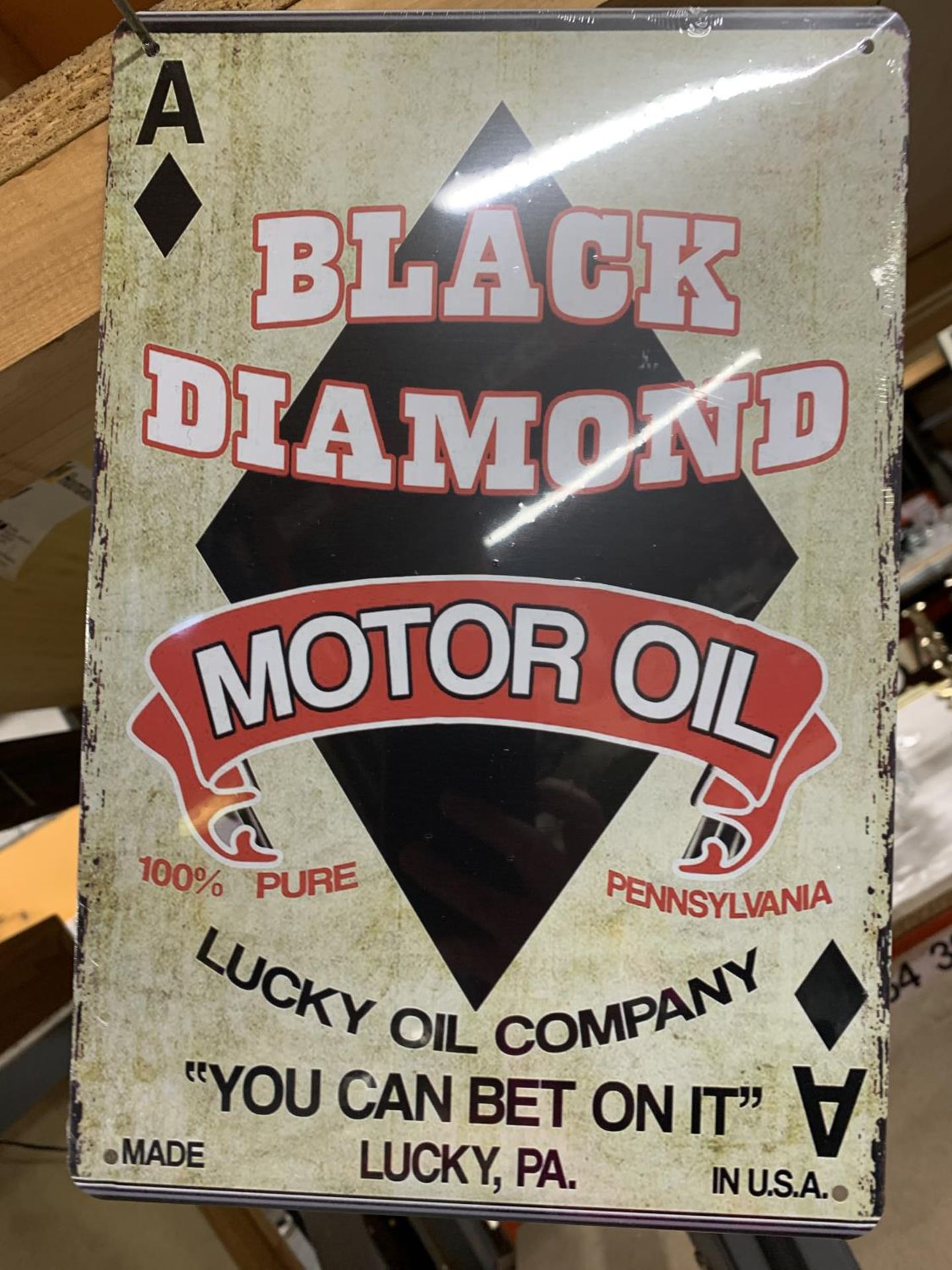 A BLACK DIAMOND MOTOR OIL METAL SIGN