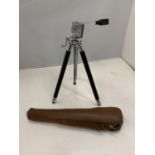 A CAMERA TRIPOD AND A LEATHER CASE