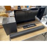 A SONY 32" TELEVISION WITH REMOTE CONTROL AN AN ONKYO SUB WOOFER AND SOUND BAR