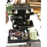 A VINTAGE SINGER PORTABLE ELECTRIC SEWING MACHINE NO 221K 1 WITH CARRY CASE, INSTRUCTIONS, OIL, A
