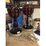A PAIR OF CRANBERRY GLASS VASES ON PLINTHS WITH GLASS DROPLETS -A/F