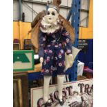 A STUDIO WARE PIERROT WITH PORCELAIN HEAD IN A WICKER CHAIR WITH A LETTER OF HISTORY