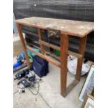 A VINTAGE WOODEN WORK BENCH WITH RECORD BENCH VICE