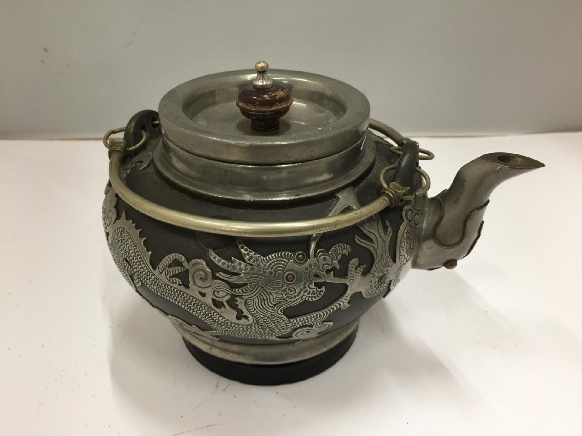 A WHITE METAL ORIENTAL TEAPOT WITHBA STAMPED TO BASE