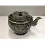 A WHITE METAL ORIENTAL TEAPOT WITHBA STAMPED TO BASE