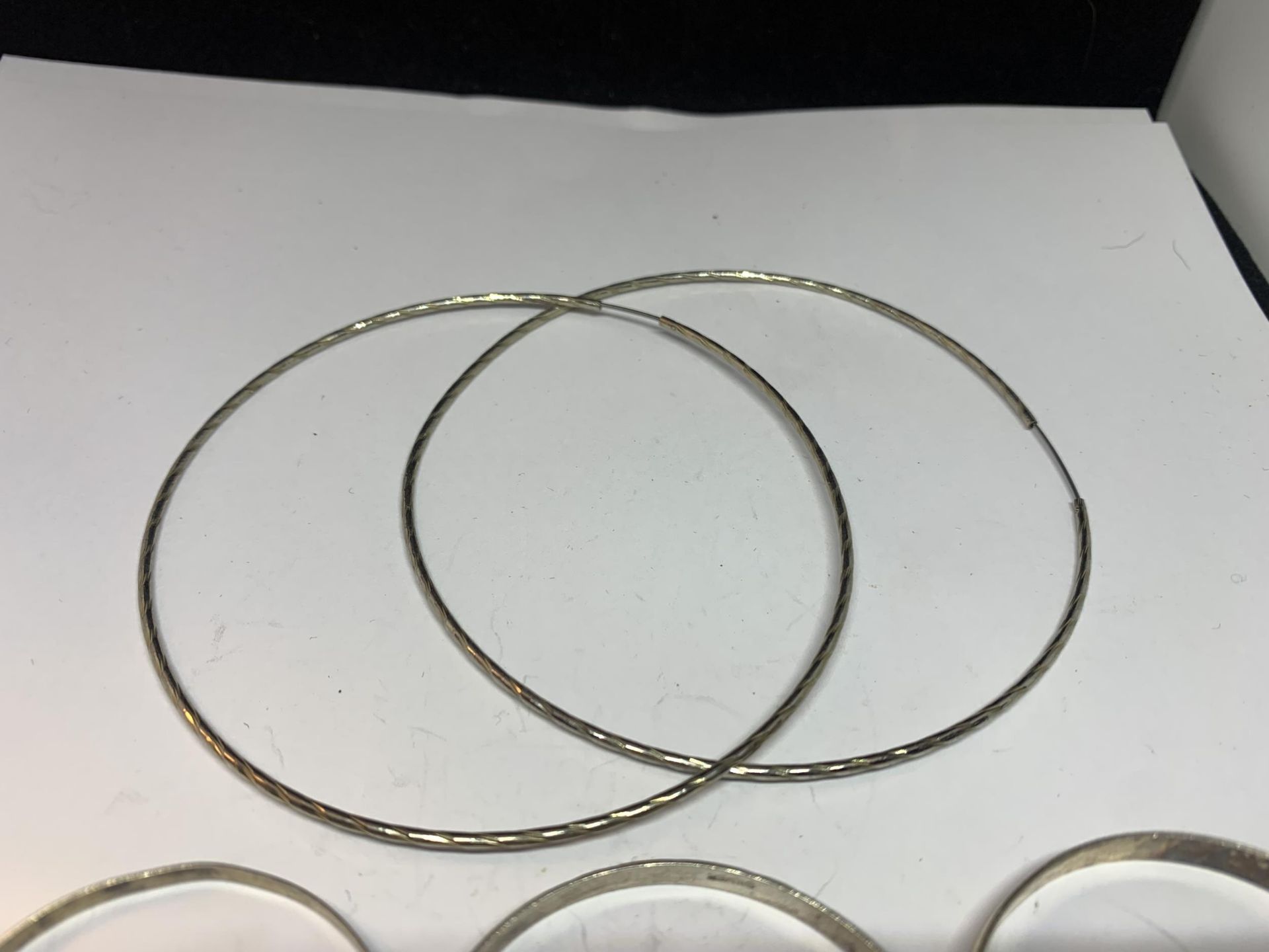 THREE SILVER CHILDRENS BANGLES AND A PAIR OF LARGE EARRINGS - Image 3 of 3
