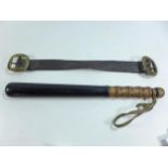 A POLICE TRUNCHEON, LENGTH 37CM, AND AN OLD LEATHER STRAP WITH BRASS BUCKLES (2)