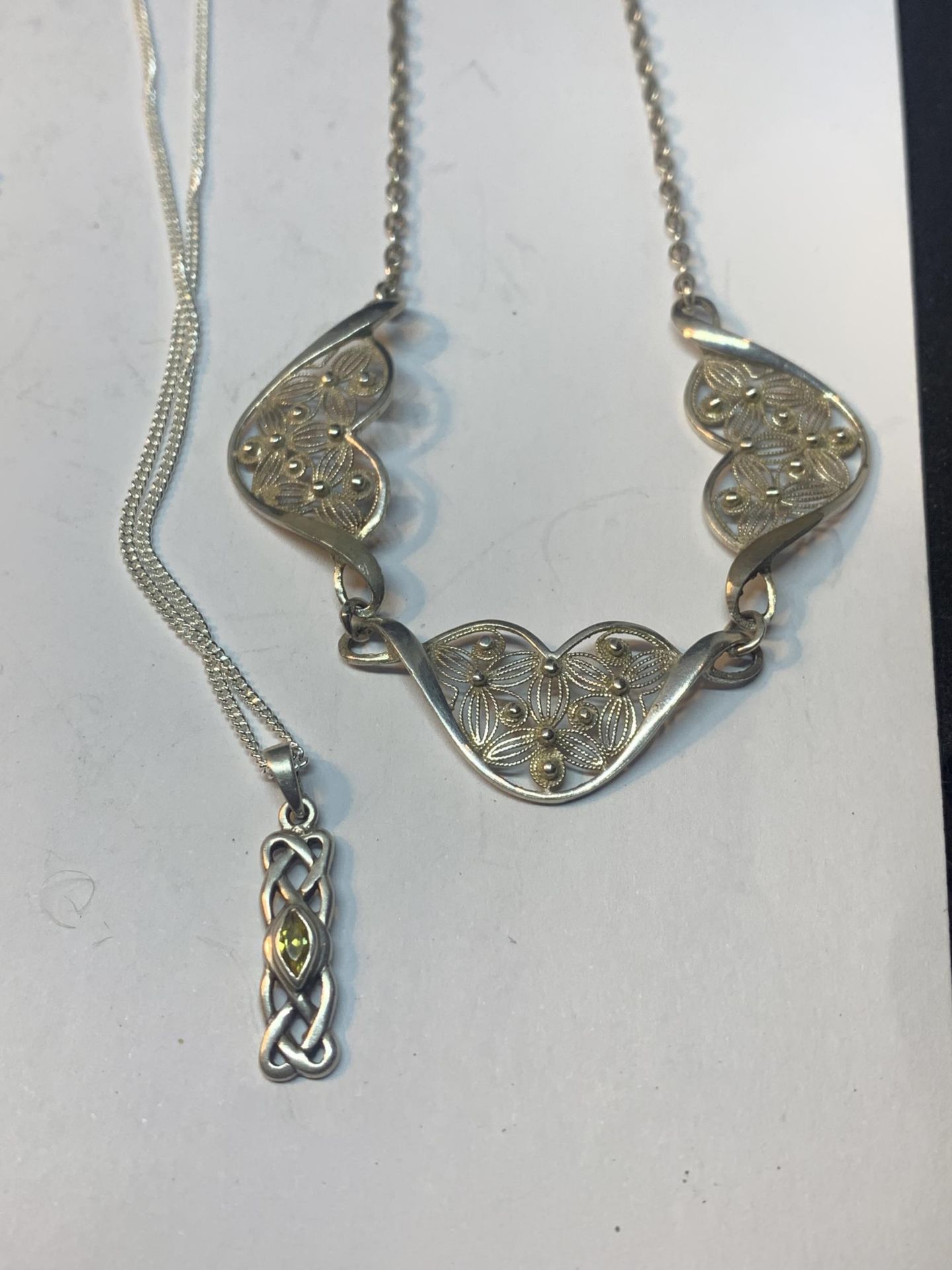 FOUR MARKED SILVER NECKLACES THREE WITH PENDANTS AND ONE WITH AN IN LINE FLOWER DESIGN - Image 3 of 3
