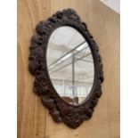 A DECORATIVE CARVED FRAMED WALL MIRROR