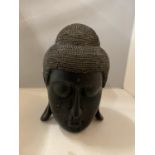 A BLACK COLOURED WOODEN BUDDAH'S HEAD HEIGHT APPROX 28CM