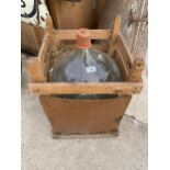 A LARGE VINTAGE GLASS CARBOY WITH RUBBER STOPPER