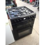 A BLACK FREESTANDING GAS AND ELECTRIC OVEN AND HOB