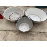 AN ENAMEL WASH BOWL, A SMALL ENAMEL BATH AND A STAINLESS STEEL COOKING POT