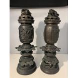 TWO BRONZE CANDLE HOLDERS IN AN ORIENTAL DESIGN