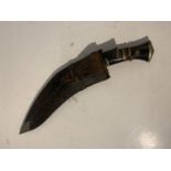 A KUKRI KNIFE WITH SCABBARD (ONE SMALLER KNIFE IS MISSING)