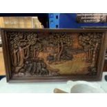A HEAVILY CARVED TREEN WALL HANGING DEPICTING ELEPHANTS AND TREES 86CM X 46CM
