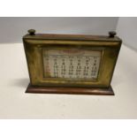 AN OAK CASED VINTAGE BRASS FRONTED PERPETUAL CALENDAR