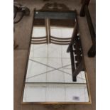 A LARGE ORNATE BRASS FRAMED WALL MIRROR