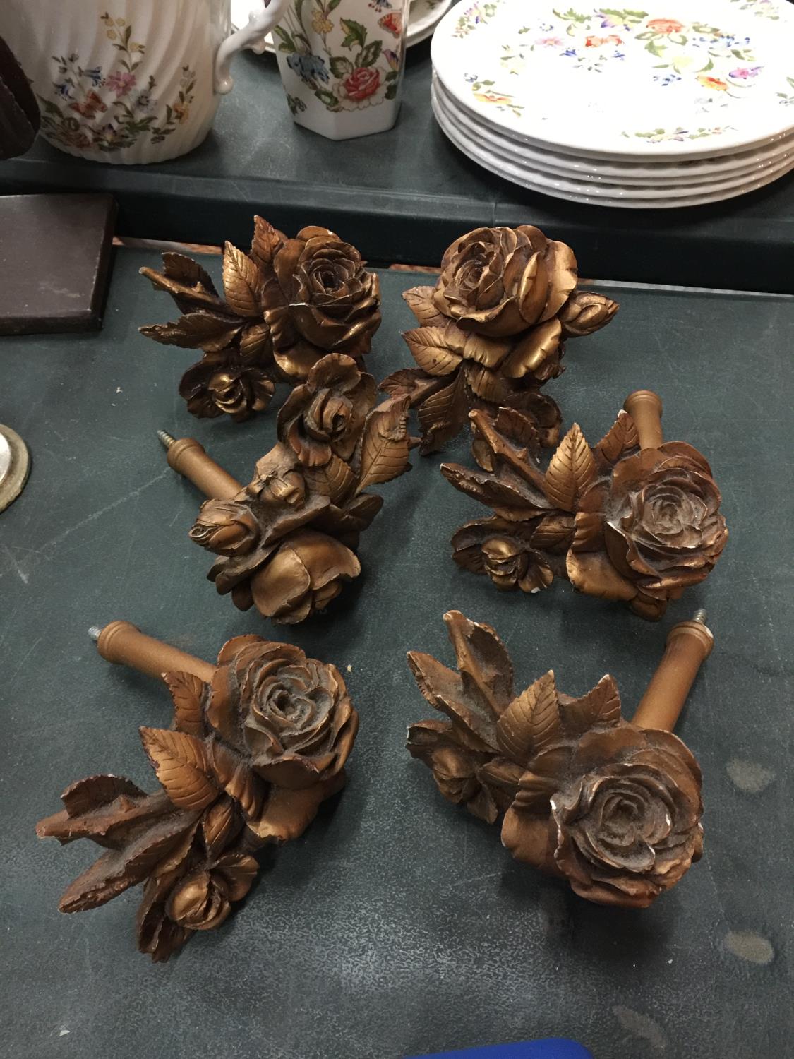 SIX CARVED WOODEN CURTAIN TIE BACKS IN THE SHAPE OF A ROSE