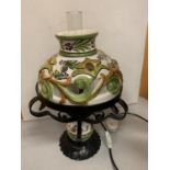 A MEDITERRANEAN STYLE WROUGHT IRON AND CERAMIC LAMP