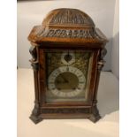 A LENZKIRCH WALNUT CHIMING BRACKET CLOCK WITH ELABORATE GILT FACE AND ENAMEL DIALS