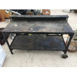 A VINTAGE METAL WORK BENCH ENCLOSING SINGLE DRAWER, WITH TWO WHEELS AND LIFTING HANDLES