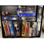 A DISPLAY CASE CONTAINING COLLECTORS SPOONS