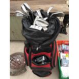 A GOLF BAG CONTAINING AN ASSORTMENT OF GOLF CLUBS TO INCLUDE IRONS AND PUTTERS ETC