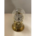 A GLASS DOMED MANTLE CLOCK WITH RISING MOON