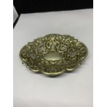 A DECORATIVE WHITE METAL DISH