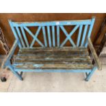 A WOODEN SLATTED GARDEN BENCH