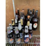 AN ASSORTMENT OF VINTAGE GLASS BOTTLES TO MAINLY CONSIST OF REAL ALE