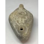 AN EGYPTIAN OIL LAMP