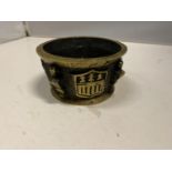 A HEAVY BRASS BOWL WITH EMBOSSED FEATURES