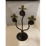 AN ARTS & CRAFTS STYLE METAL CANDLESTICK FOR THREE CANDLES