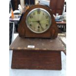 A VINTAGE WOODEN CASED MANTLE CLOCK WITH WOODEN PLINTH BASE