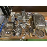 A LARGE AMOUNT OF SILVER PLATE ITEMS TO INCLUDE, CANDLESTICKS, CRUETS, JUGS, CUTLERY, SERVING