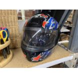 A BLACK, RED, AND BLUE AGV MOTORBIKE HELMET