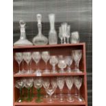 A LARGE COLLECTION OF GLASS WARE TO INCLUDE DECANTORS, WINE GLASSES AND SHERRY GLASSES ETC