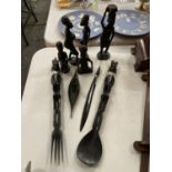 A QUANTITY OF AFRICAN THEMED WOODEN-POSSIBLY EBONY- FIGURES TO INCLUDE, MEN, WOMEN , FORK, SPOON,