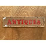 A VINTAGE WOODEN PAINTED 'ANTIQUES' SIGN