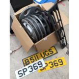 AN ASSORTMENT OF CAR SPARES TO INCLUDE VARIOUS WHEEL HUBS, A MAZDA GRILL AND NUMBER PLATES ETC