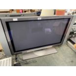 A HITACHI 32" TELEVISION WITH SIDE SPEAKERS MODEL NO. 32PD5000