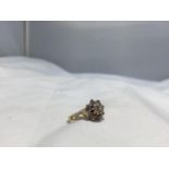 A 9 CARAT GOLD RING WITH DIAMONDS IN A CLUSTER FORMATION SIZE L