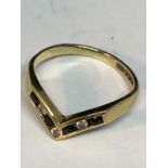 A 9 CARAT GOLD WISHBONE RING FOUR SAPPHIRES AND THREE DIAMONDS IN LINE SIZE J